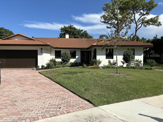 view of front facade with a garage and a front lawn