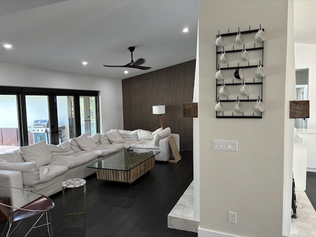 living room with ceiling fan and hardwood / wood-style flooring