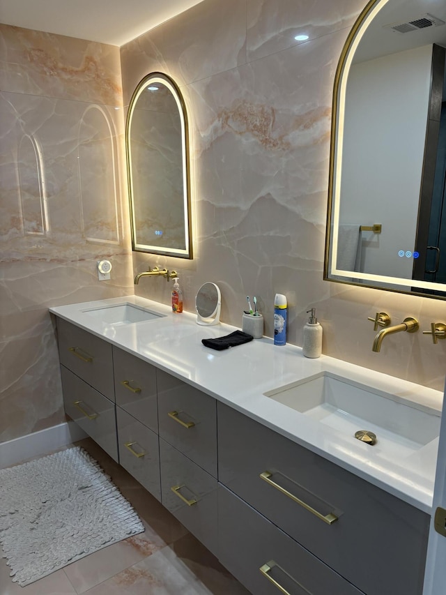 bathroom with tile walls, tile patterned flooring, vanity, and decorative backsplash