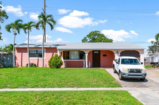 single story home featuring a garage and a front lawn