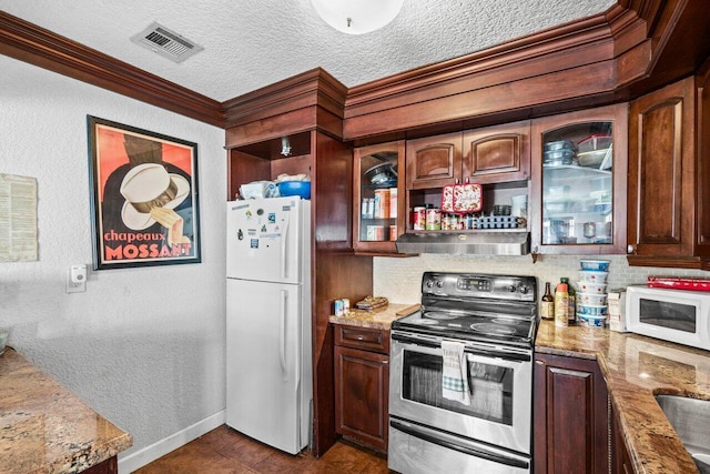 kitchen with white appliances, a textured ceiling, light stone counters, and extractor fan