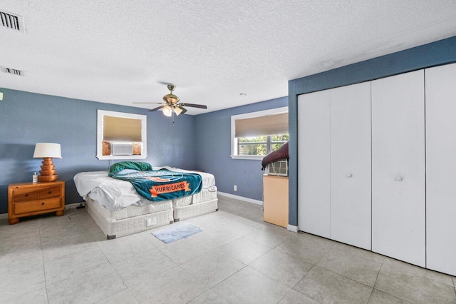 bedroom featuring a textured ceiling and ceiling fan