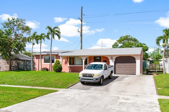 ranch-style home with a garage and a front lawn