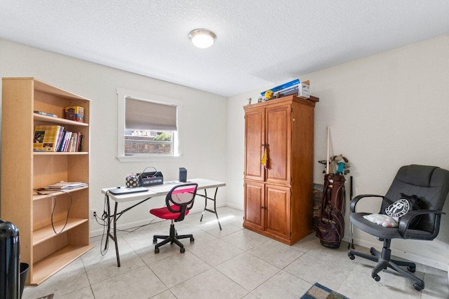 office space featuring a textured ceiling and light tile patterned flooring