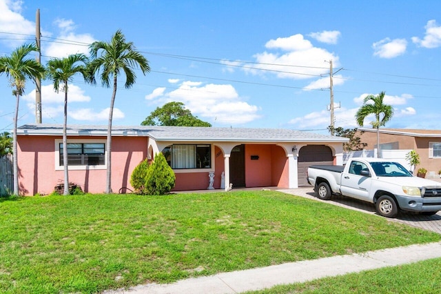 ranch-style home with a front lawn and a garage