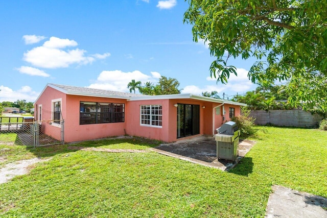 rear view of house featuring a lawn