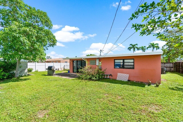 rear view of property featuring a yard