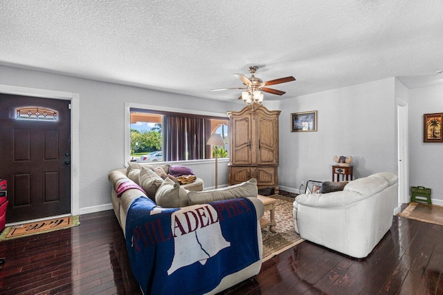 living room featuring a textured ceiling, dark hardwood / wood-style flooring, and ceiling fan