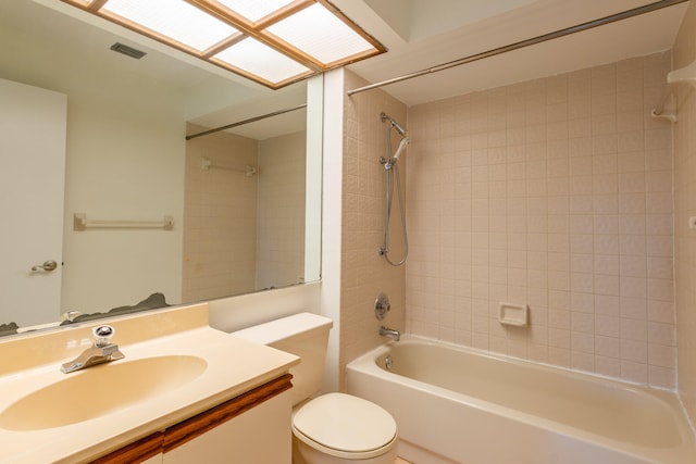 full bathroom with vanity, toilet, and tiled shower / bath combo