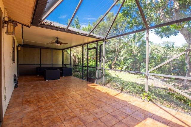 unfurnished sunroom with a healthy amount of sunlight and ceiling fan