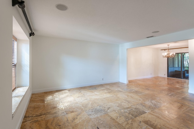 empty room featuring a notable chandelier