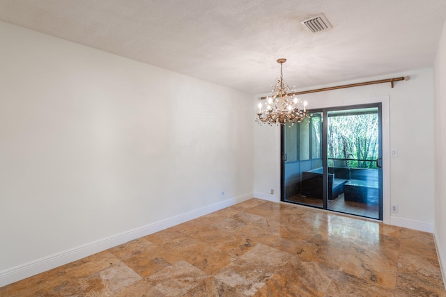 spare room with a chandelier