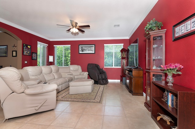 tiled living room with ceiling fan and crown molding