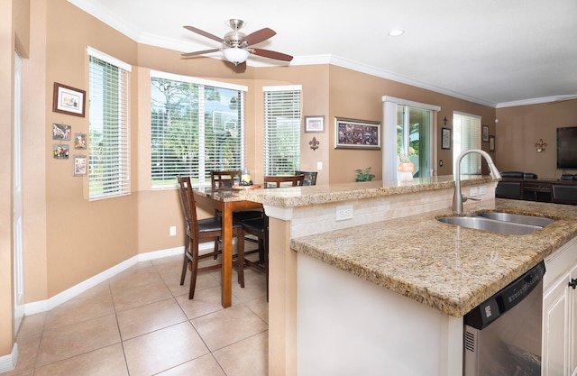 kitchen with a healthy amount of sunlight, dishwasher, crown molding, and sink