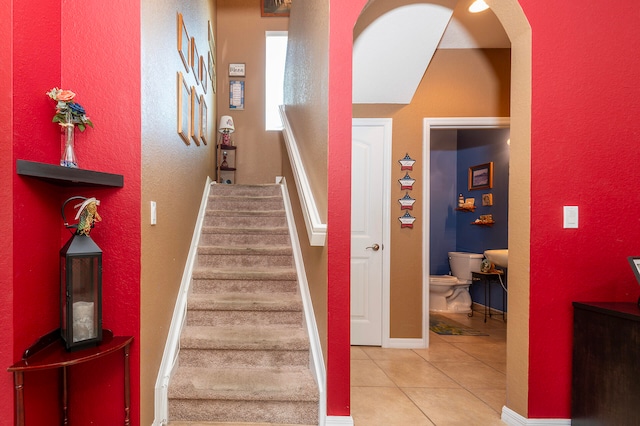 stairs with tile patterned floors