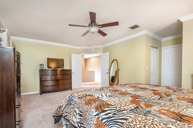 bedroom featuring a textured ceiling, ornamental molding, ceiling fan, and light colored carpet