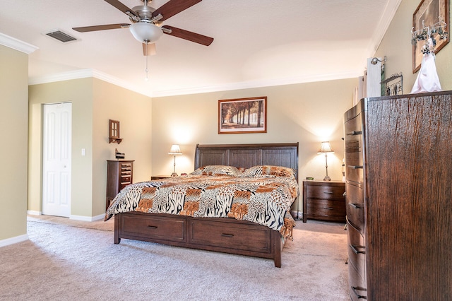 carpeted bedroom with ceiling fan, a closet, and crown molding