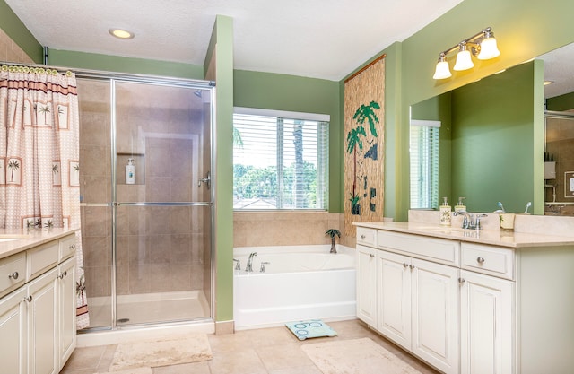 bathroom featuring tile patterned floors, a textured ceiling, independent shower and bath, and vanity