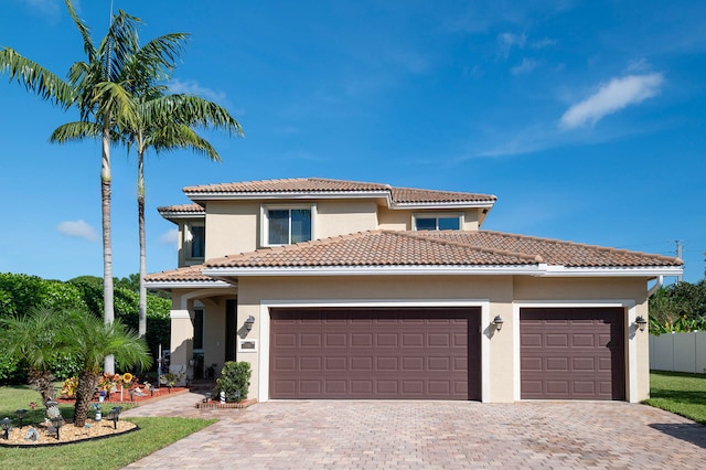 mediterranean / spanish home featuring a garage