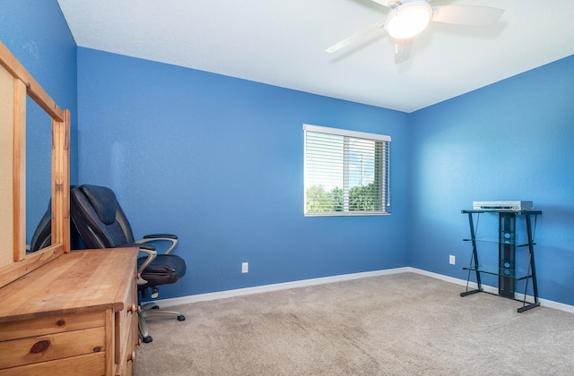 carpeted office featuring ceiling fan