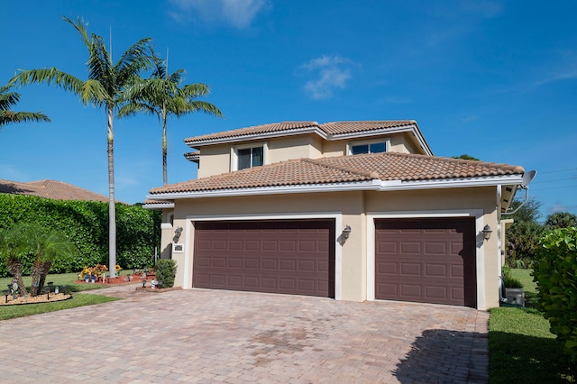 mediterranean / spanish home with a garage