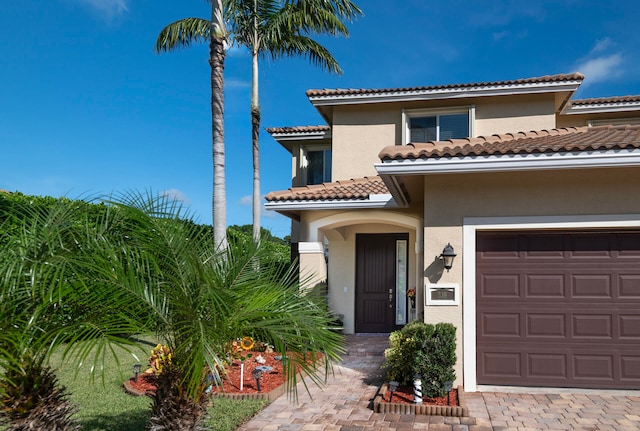 mediterranean / spanish house with a garage