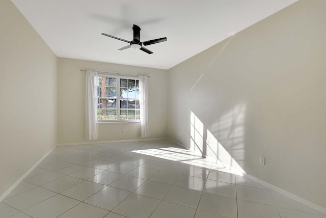 empty room featuring light tile patterned floors and ceiling fan