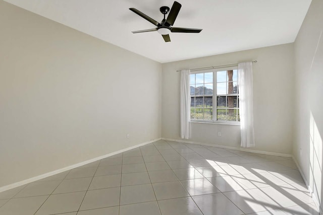 spare room featuring ceiling fan and light tile patterned floors