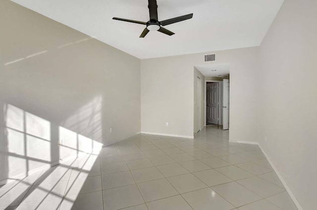 unfurnished room with ceiling fan and light tile patterned flooring