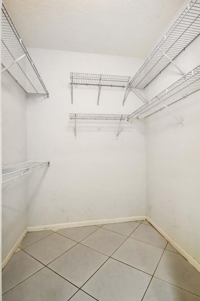 walk in closet featuring tile patterned flooring