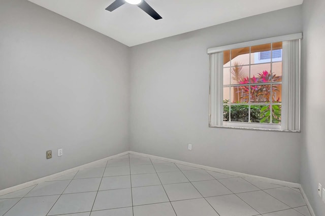 spare room featuring light tile patterned floors and ceiling fan