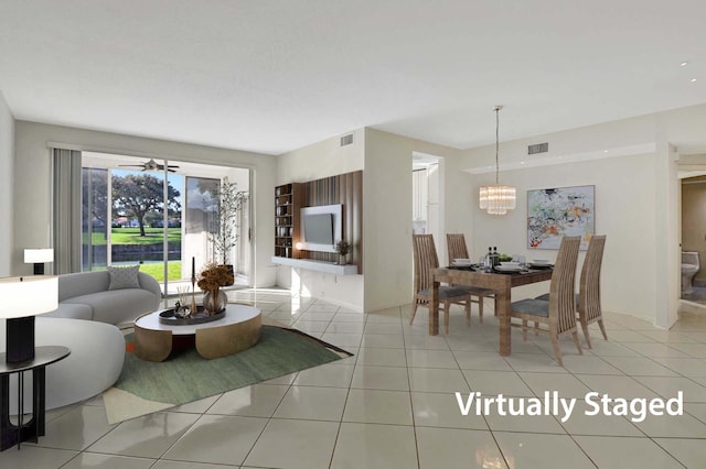 living room featuring ceiling fan with notable chandelier and light tile patterned floors