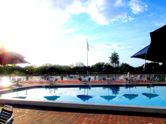 view of pool featuring fence