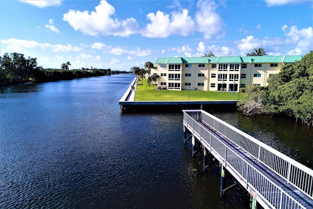 view of dock featuring a yard and a water view