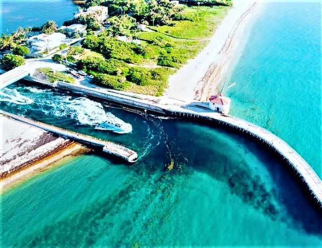 bird's eye view featuring a view of the beach and a water view