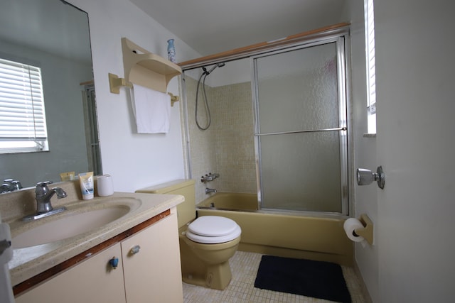 full bathroom with bath / shower combo with glass door, vanity, toilet, and tile patterned floors