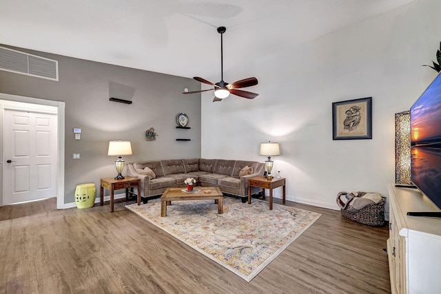 living room featuring ceiling fan and hardwood / wood-style flooring