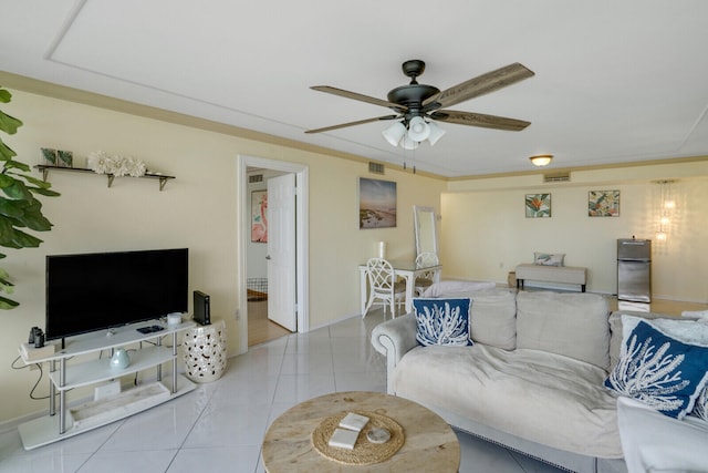 living room featuring ceiling fan, crown molding, and light tile patterned floors