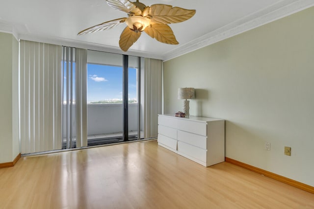 interior space featuring ceiling fan, ornamental molding, and light hardwood / wood-style floors