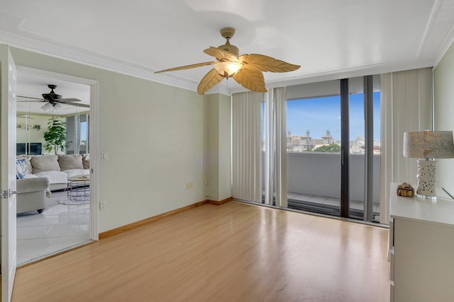 unfurnished room with ceiling fan, a wealth of natural light, and wood-type flooring