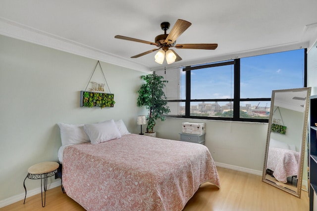 bedroom with ceiling fan and light hardwood / wood-style flooring