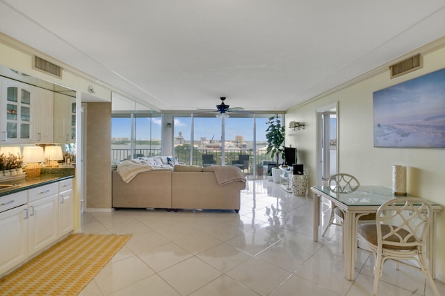 living room featuring ceiling fan and light tile patterned floors