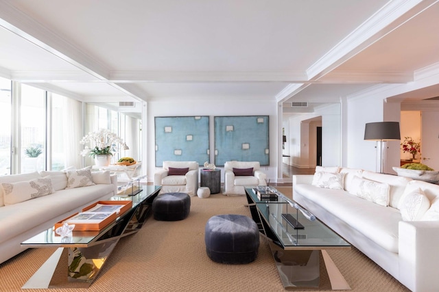 carpeted living room featuring ornamental molding and beam ceiling