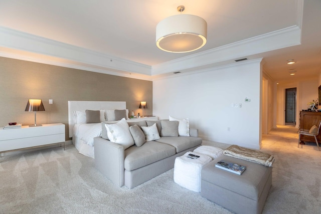 carpeted bedroom with crown molding and a raised ceiling