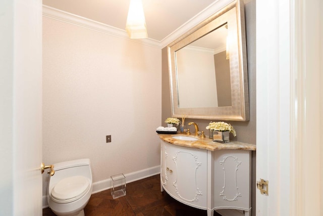 bathroom with ornamental molding, parquet flooring, vanity, and toilet