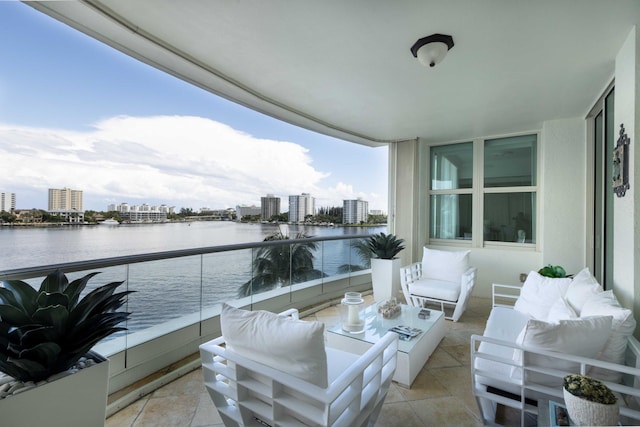 balcony featuring a water view and an outdoor hangout area