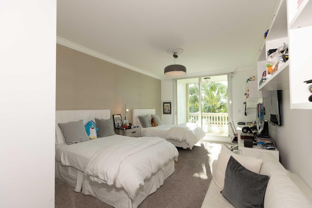 carpeted bedroom featuring ornamental molding and access to exterior