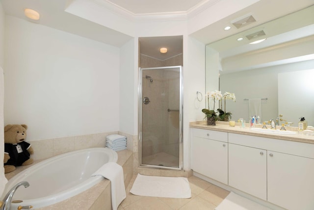 bathroom with plus walk in shower, ornamental molding, tile patterned floors, and vanity