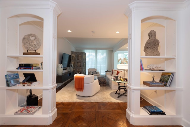 living room with dark parquet flooring and crown molding