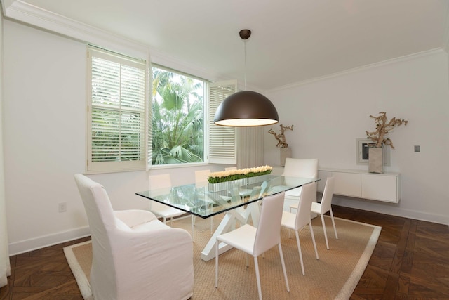 dining area featuring dark parquet flooring and ornamental molding